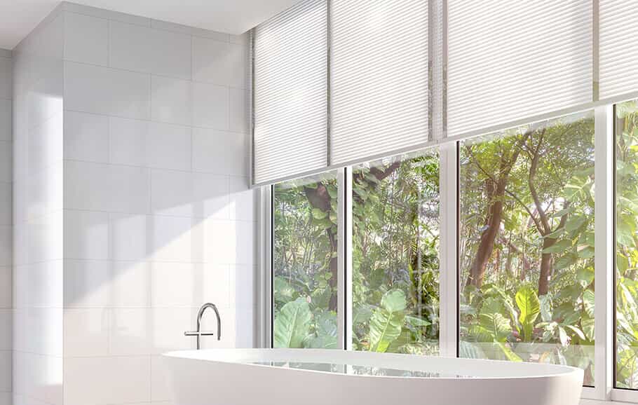 Window treatments on large bathroom windows in Benbrook home